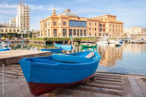 Fototapeta Naklejka Na Ścianę i Meble -  Little Harbor with wooden boats and theater in the background, Bari, Puglia, Italy