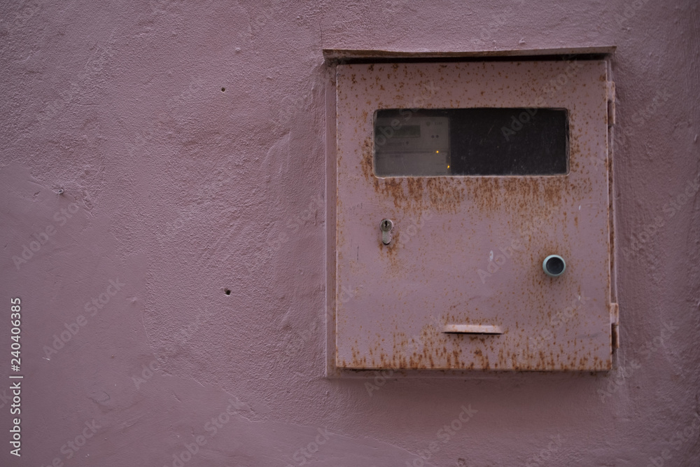 Vintage texture pink mailbox on a pink concrete wall