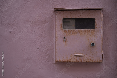 Vintage texture pink mailbox on a pink concrete wall