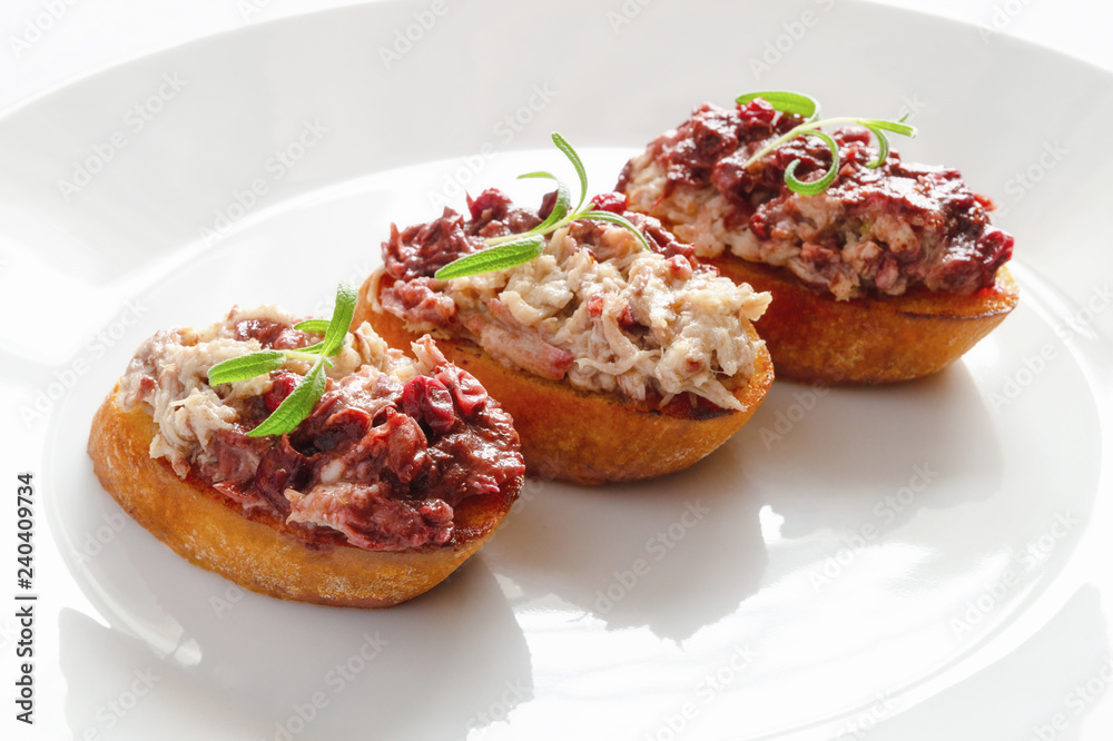 toasts with rabbit rillettes toppled with cranberry red wine confiture and decorated with rosemary toasts with rabbit rillettes toppled with cranberry red wine confiture and decorated with rosemary