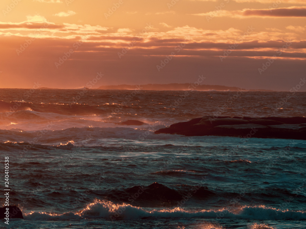 Fototapeta premium Winter waves at Peggy's Cove in Nova Scotia during sunset, peaceful, waves, powerful.