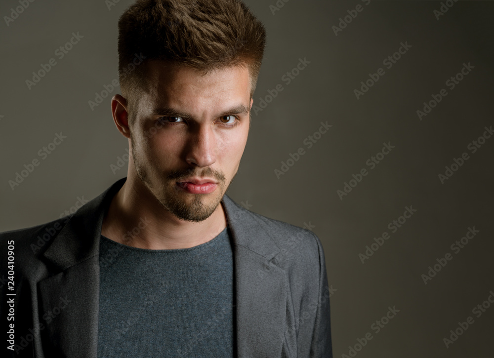 Obraz premium Fashion portrait of man. fashion man with unshaven beard. facial emotions. male grooming and barber. man. Beard and facial care. serious and confident businessman, copy space. Business professionals