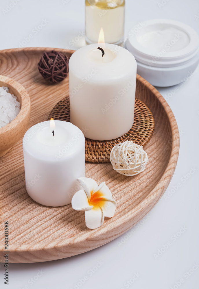 Candles, body care products and accessories on the white background