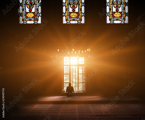 Young man praying in the mosque