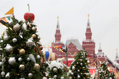 New Year celebration in Russia, Christmas decorations on Red Square in Moscow. Christmas trees on background of State historical museum during snowfall