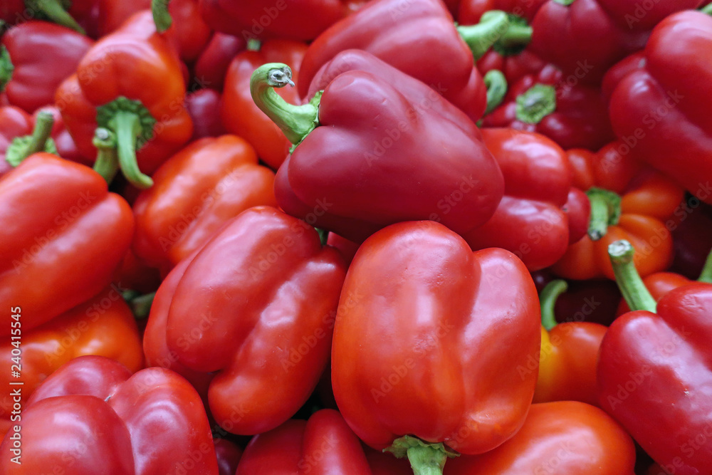 many scattered ripened red pepper fruits in the store