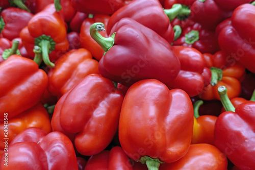 many scattered ripened red pepper fruits in the store