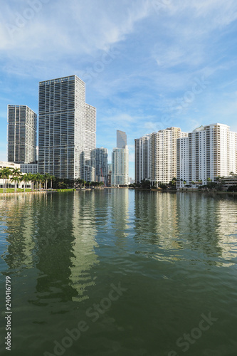 Miami  Florida 09-08-2018 Buildings of the City of Miami and Brickell Key and their reflections on the tranquil water of Biscayne Bay.