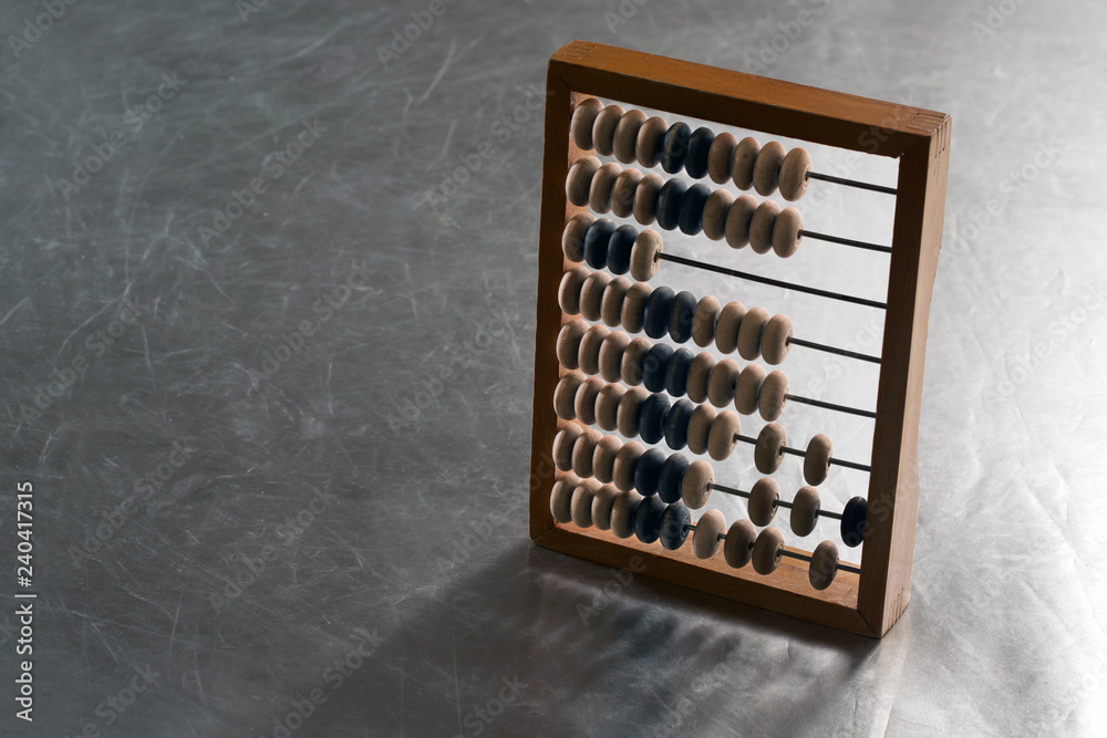 Wooden abacus on a metal surface Wooden abacus on a metal surface