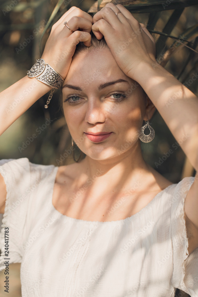 Obraz premium Sexy sensual portrait of a girl, Model in white dress on the background of reeds 