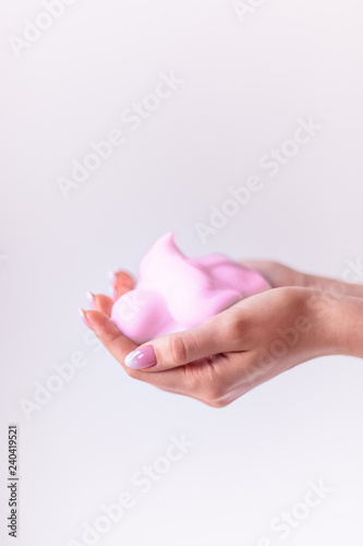 pink foam in the palms, hands full of mousse, skin care for girls