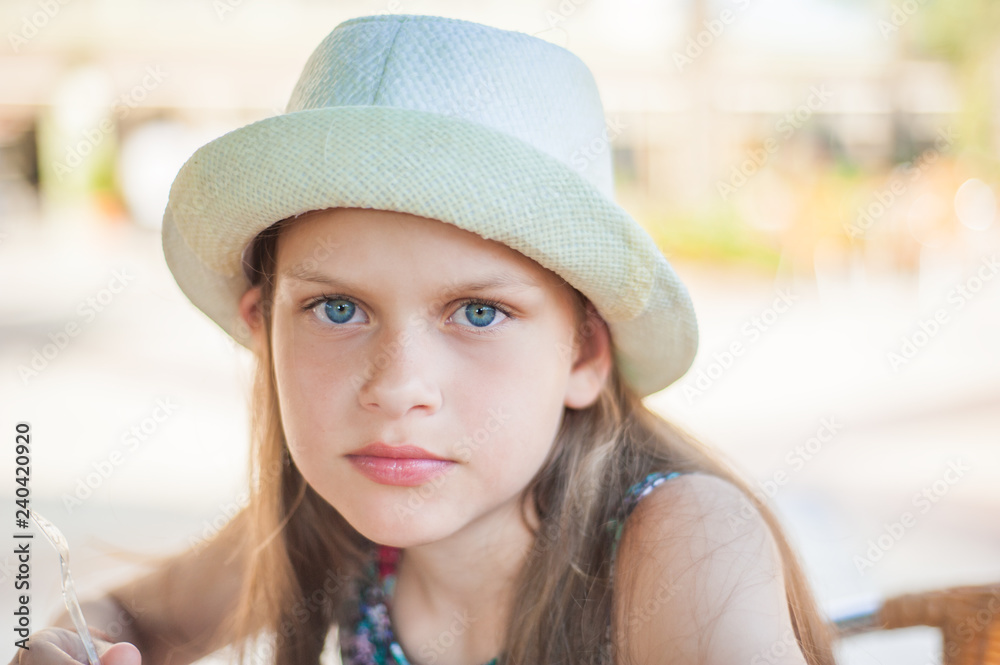 little girl in straw hat at beach background