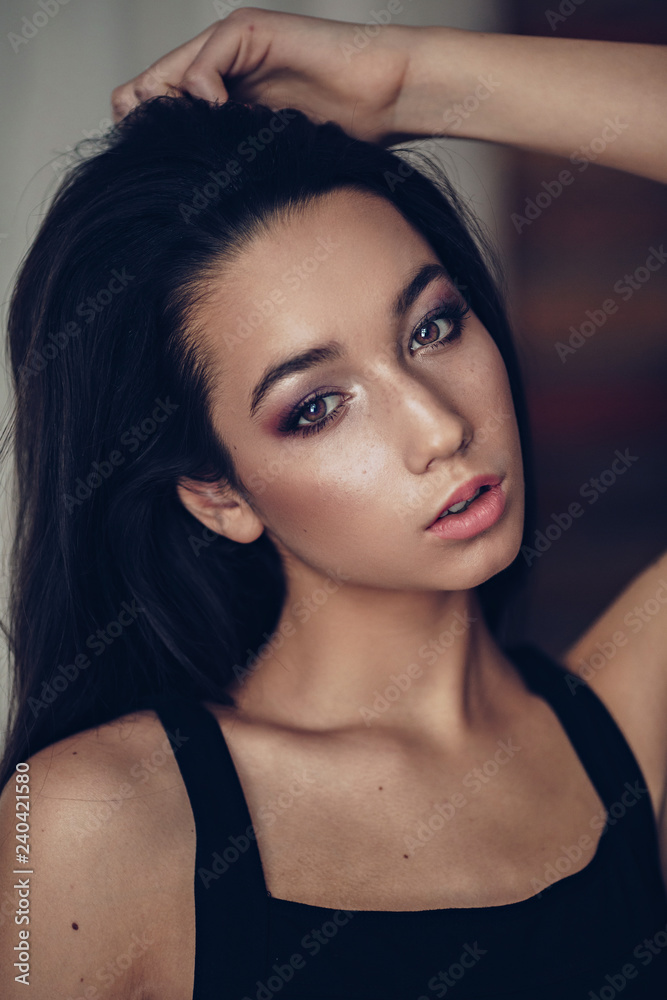 Portrait of beautiful brunette girl with makeup in fashion black clothes Portrait of beautiful brunette girl with makeup in fashion black clothes