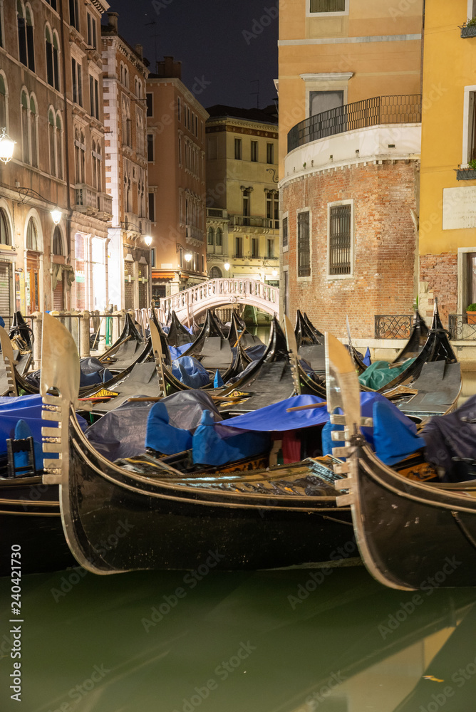 Night view of the water widening of the Orseolo basin located in Venice in the San Marco district, Italy. Mirror of water with Gondolas.