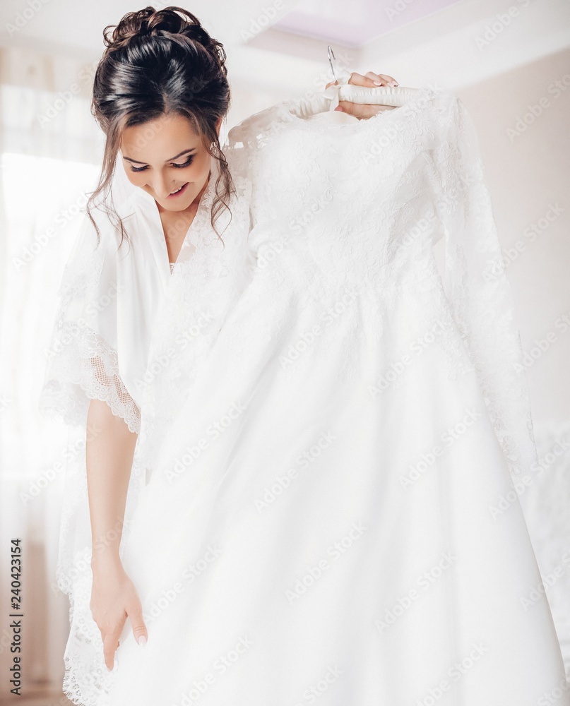 Beautiful brunette bride with stylish make-up in white dress Beautiful brunette bride with stylish make-up in white dress