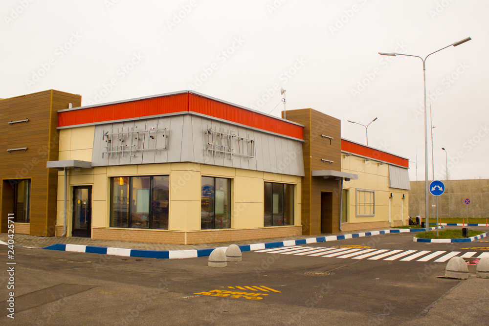 ST. PETERSBURG RUSSIA-NOVEMBER 11, 2018: Construction of a new fast food restaurant Burger King. The building without names and logos before opening. Symbols and logo lies near building. Exterior ST. PETERSBURG RUSSIA-NOVEMBER 11, 2018: Construction of a new fast food restaurant Burger King. The building without names and logos before opening. Symbols and logo lies near building. Exterior