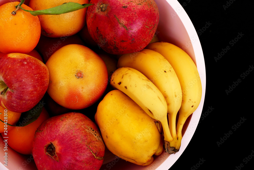winter fruit in the fruit bowl, apples, oranges, tangerines, bananas, pomegranates, quince winter fruit in the fruit bowl, apples, oranges, tangerines, bananas, pomegranates, quince