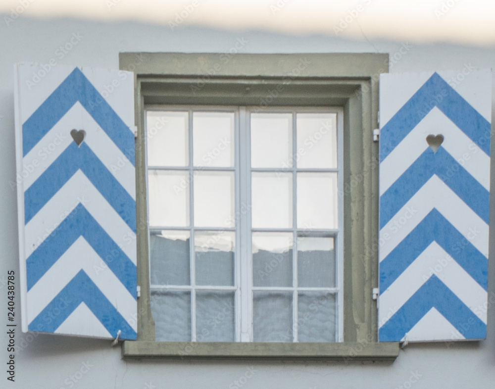 Fototapeta premium Typical german window with open colorful shutters 