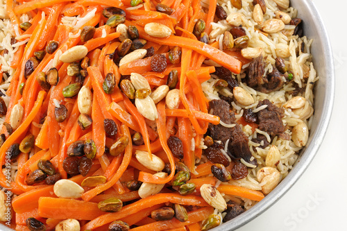Delicious, colorful Afghan rice pilaf ( Kabuli Pilaf) with lamb or chicken meat and raisin, carrot, pistachio, almond, spices.