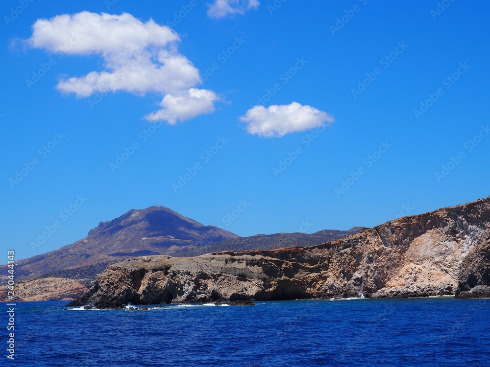 sea and mountains with blue sky and white clouds