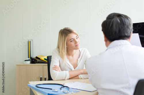 Woman patient talking to doctor psychiatrist in hospital,Discuss issue and find solutions to mental health problems