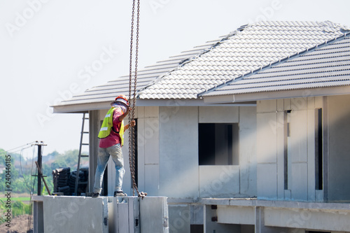 Construction worker are installing Crane hooks at the precast concrete wall, Precast house construction.
