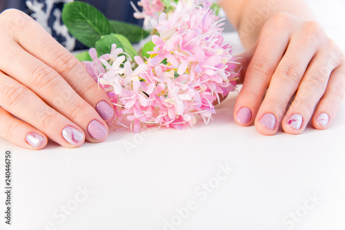 female hand skin care - hands holding flowers