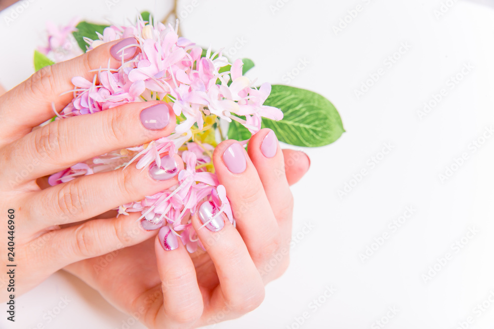female hand skin care - hands holding flowers female hand skin care - hands holding flowers
