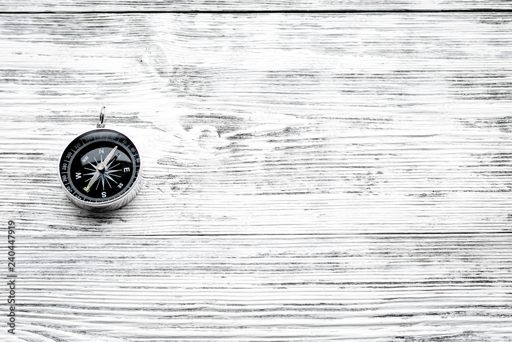 Direction of movement. Compass on gray wooden background top view copy space Direction of movement. Compass on gray wooden background top view copy space