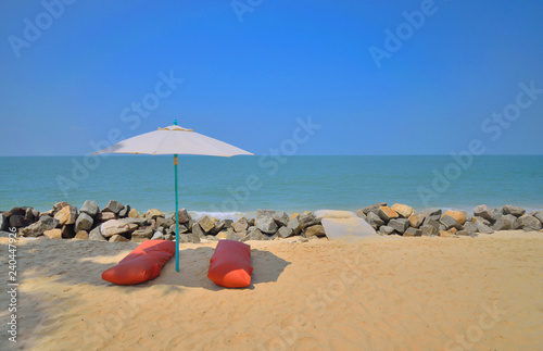 White Umbrella providing shade in the beautiful marari sea beach.