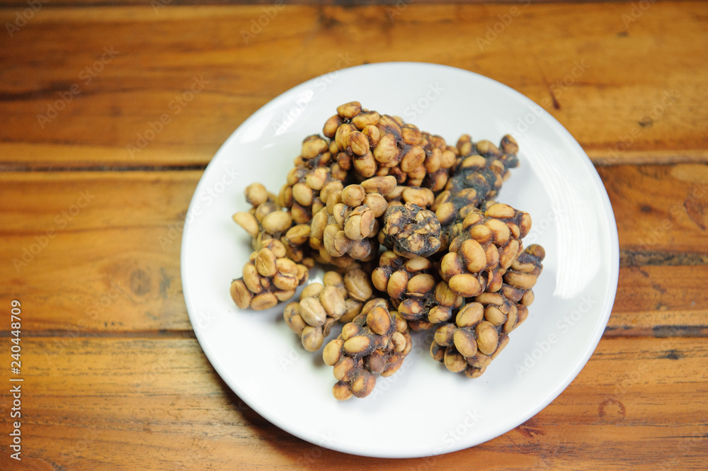 Weasel coffee beans on dish Weasel coffee beans on dish
