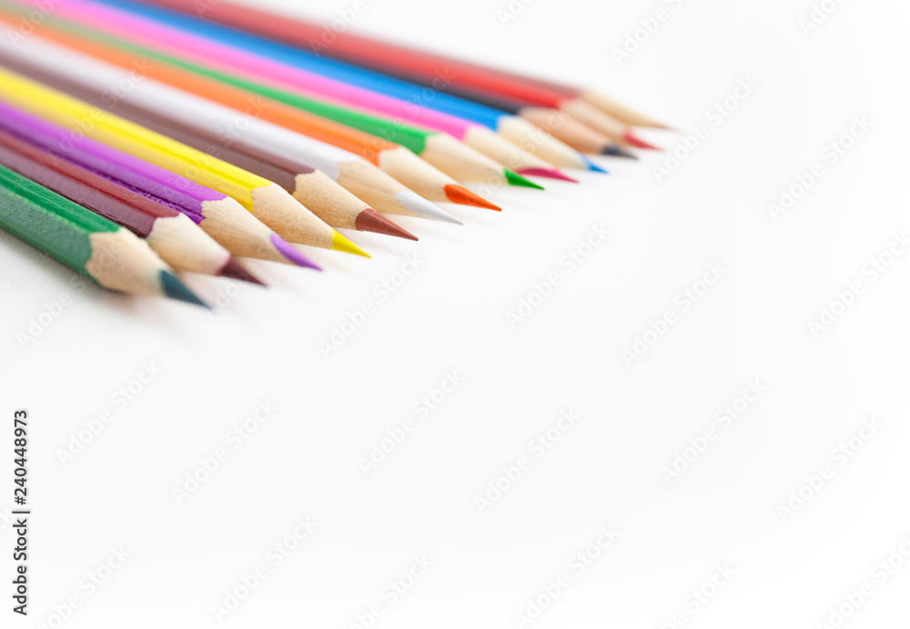 Closeup, Selective focus on the tips of the colorful crayon pencils on white background with copy space. Closeup, Selective focus on the tips of the colorful crayon pencils on white background with copy space.