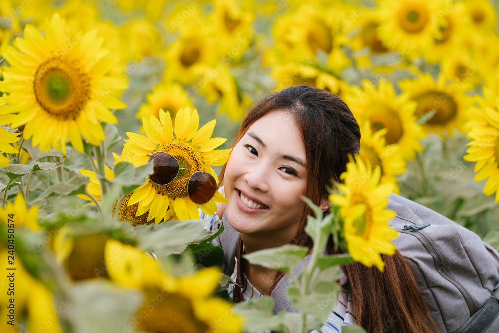 Beauty joyful teenage girl with sunflower enjoying nature and laughing on summer sunflower field. Beauty joyful teenage girl with sunflower enjoying nature and laughing on summer sunflower field.