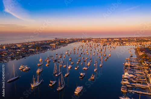 Drone shot of Newport Beach harbor in Orange County, California early in the morning with boats below. photo