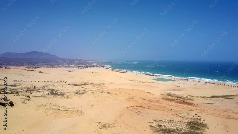 aerial panorama pictorial deserted yellow sandy coast by endless azure ocean under clear blue sky aerial panorama pictorial deserted yellow sandy coast by endless azure ocean under clear blue sky