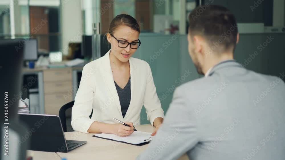 pretty-woman-recruiter-is-talking-to-male-candidate-during-job