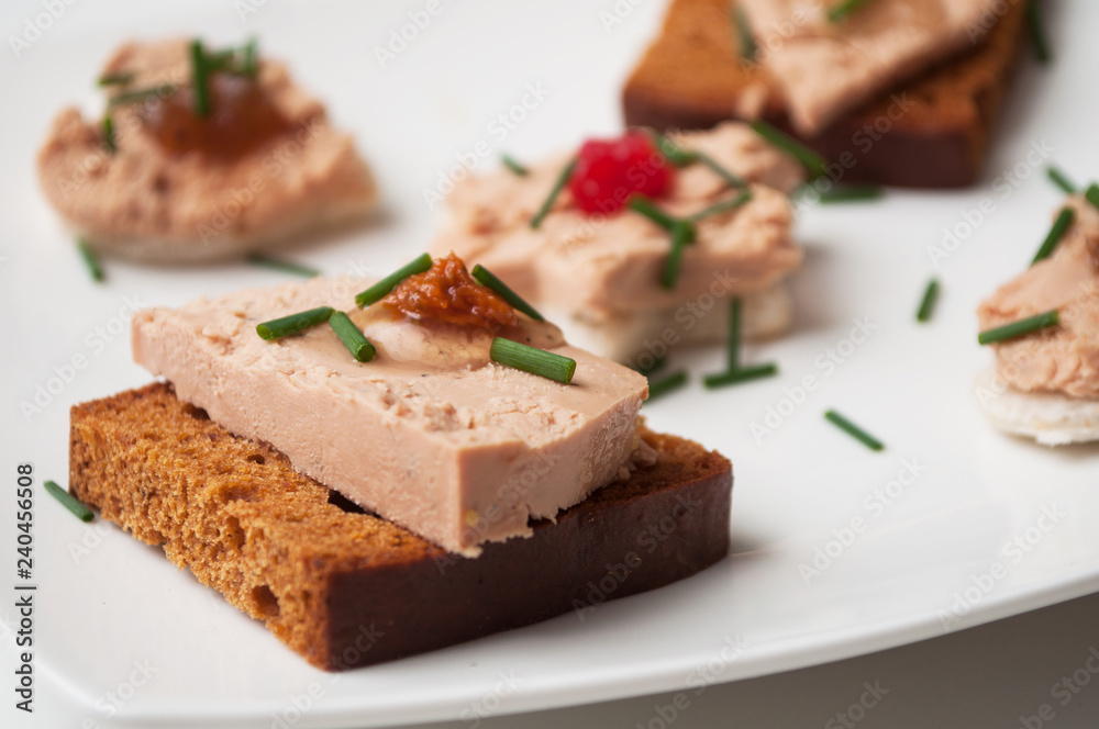closeup of foie gras on gingerbread in festive plate closeup of foie gras on gingerbread in festive plate