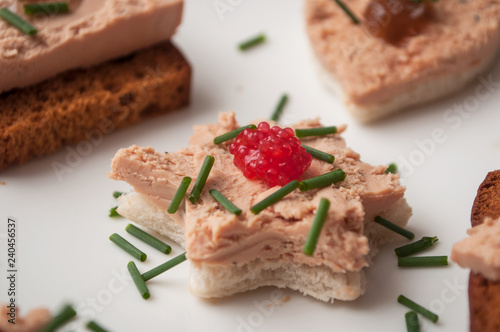 closeup of foie gras on bread in shaped star in festive plate