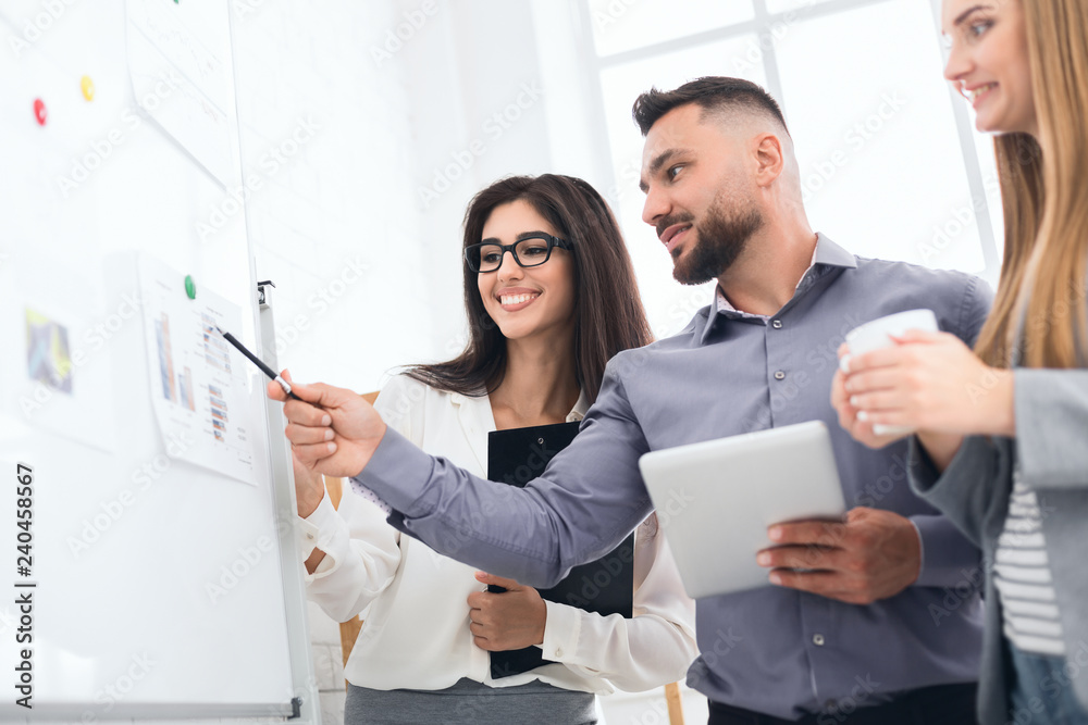 Discussing project together. Confident man showing graphics Discussing project together. Confident man showing graphics