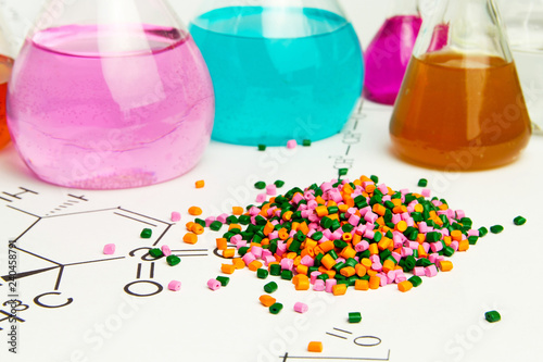 Plastic raw material in granules against the background of Chemical Laboratory and reagents. Polypropylene, Ethylene, Polypropylene research in laboratory conditions