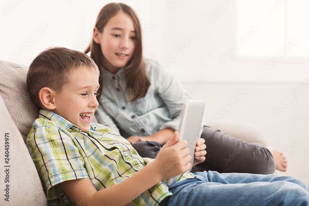 Little boy sharing funny content on digital tablet Little boy sharing funny content on digital tablet