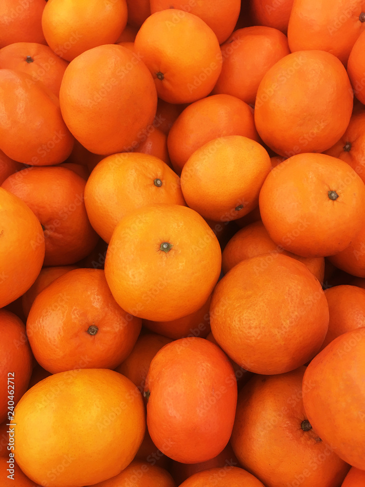 Healthy fruits, orange fruits background many orange fruits - orange fruit background in a supermarket super store