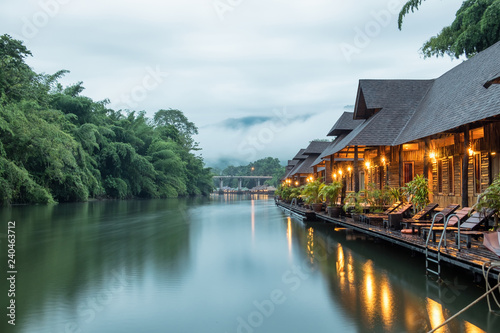 Resort wooden house floating and mountain fog on river kwai photo