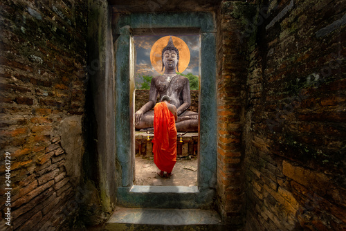 Asia novice monk worship the Buddha with faith.Buddhist monk sacred Buddha statue depicting a religious faith in a temple in country Southeast Asia. - Image