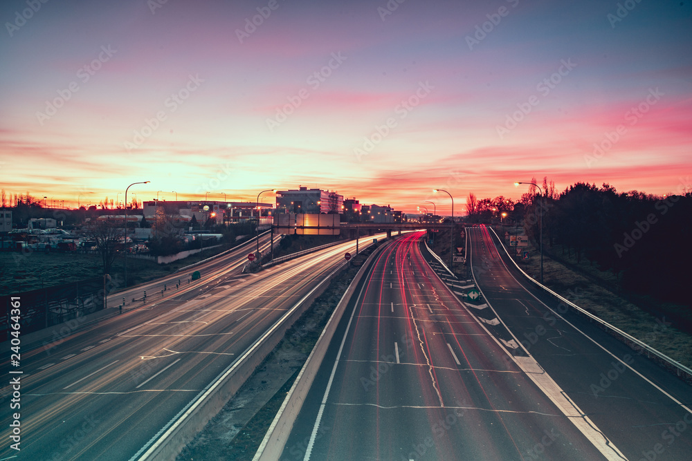 Wake of lights on highway at dawn Wake of lights on highway at dawn