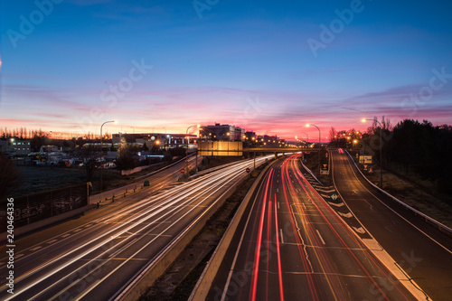 Wake of lights on highway at dawn