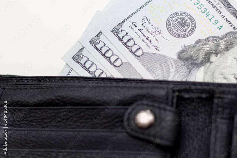 Dollar banknotes in leather wallet on white background Dollar banknotes in leather wallet on white background