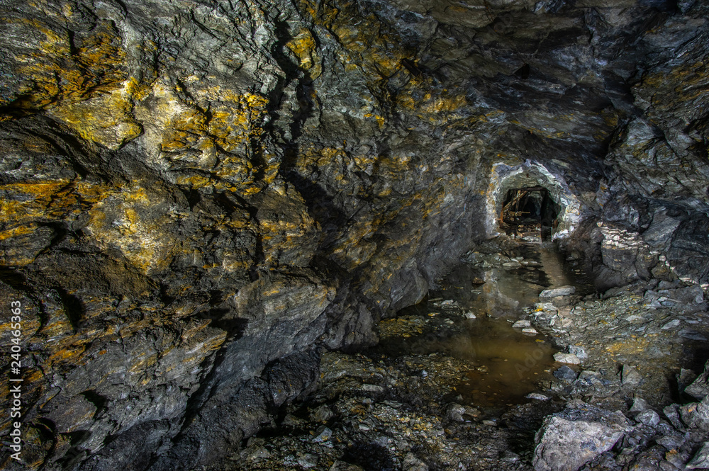 Golden rock in the old mine