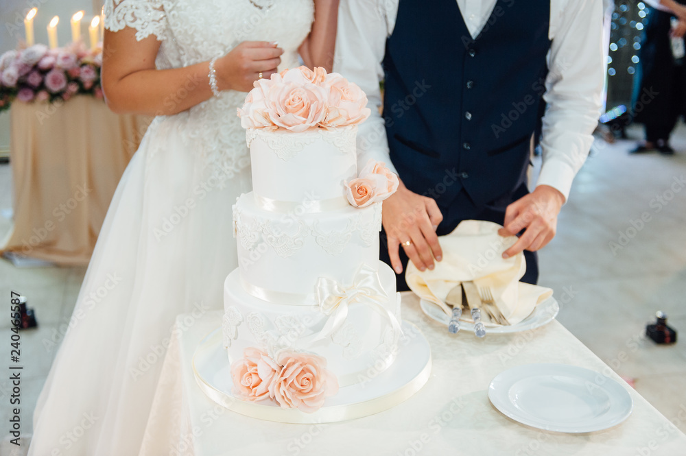 Wedding ceremony. Bride and groom cutting cake Wedding ceremony. Bride and groom cutting cake