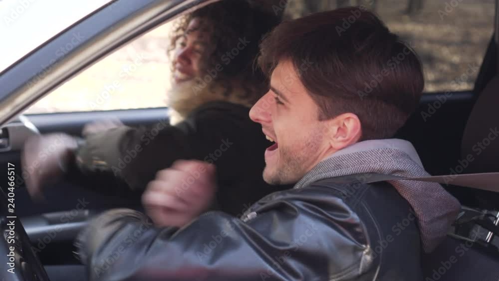 Couple sitting and dancing in car Couple sitting and dancing in car